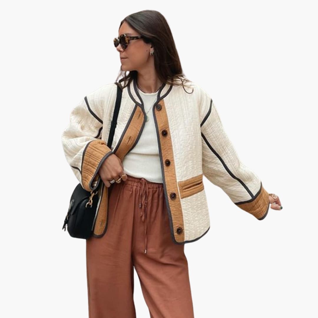 Women's quilted jacket with button closure, round neckline, contrast piping, and front pockets for everyday wear