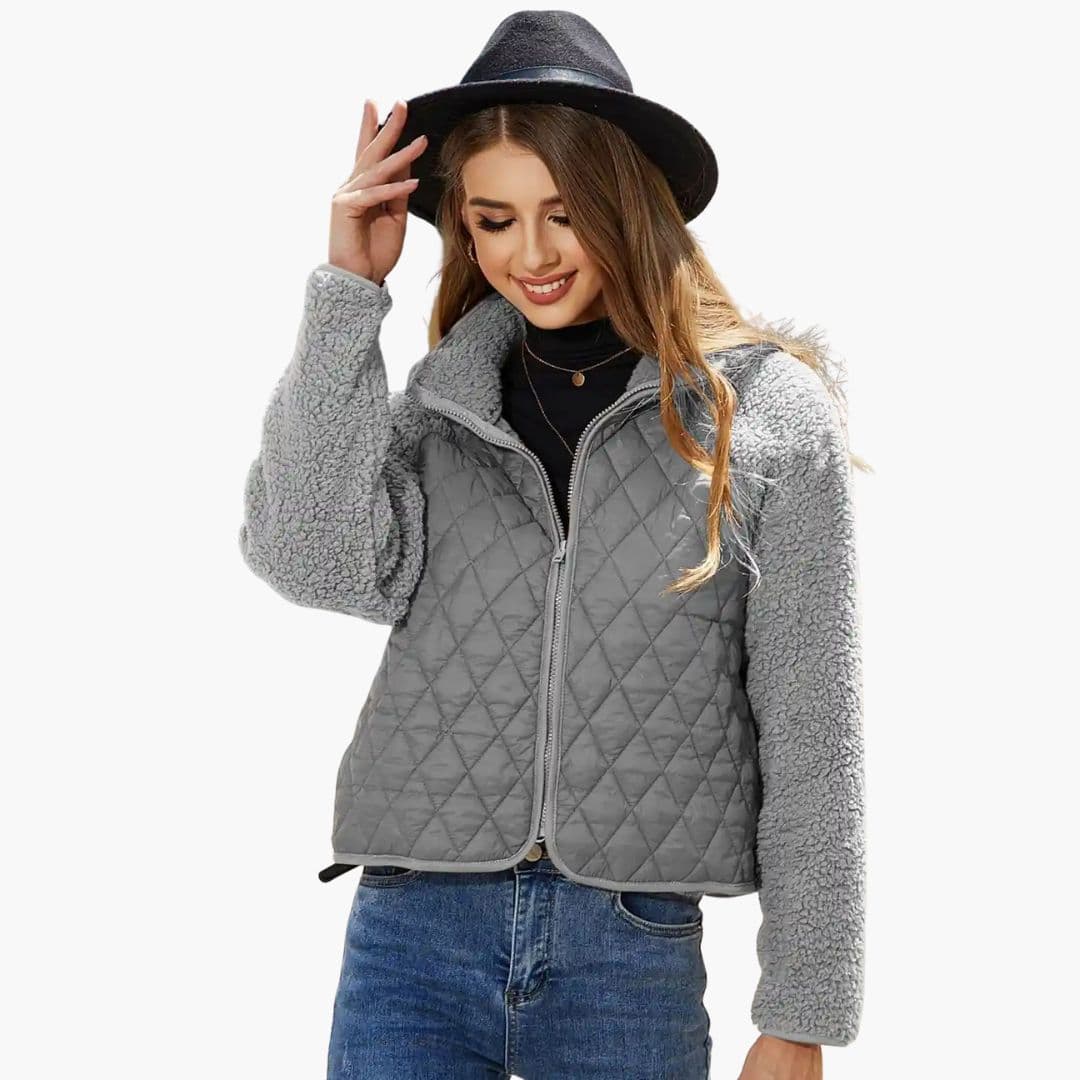 Women's black quilted zip jacket with textured sleeves, stand-up collar, and hip-length silhouette