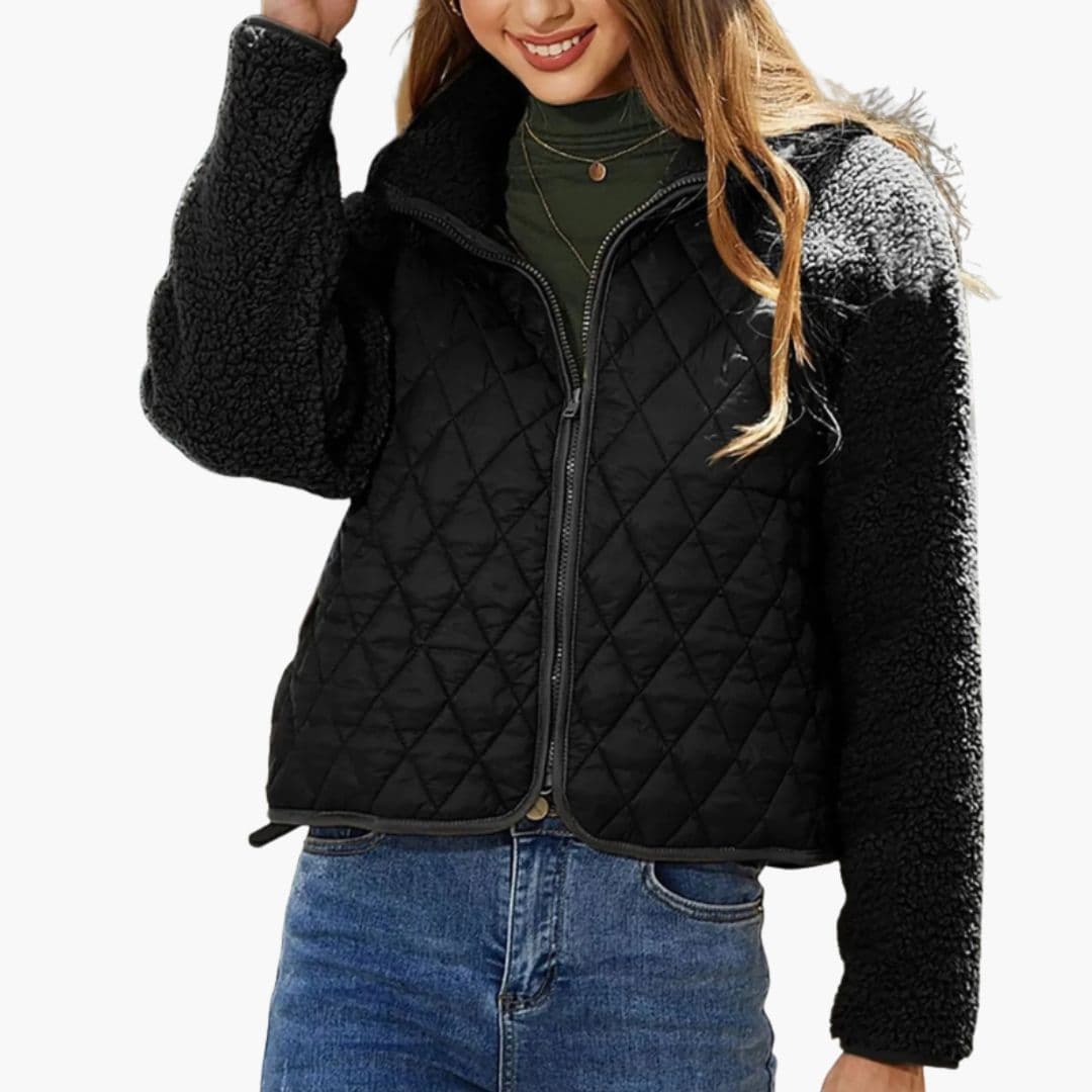 Women's black quilted zip jacket with textured sleeves, stand-up collar, and chic hip-length fit