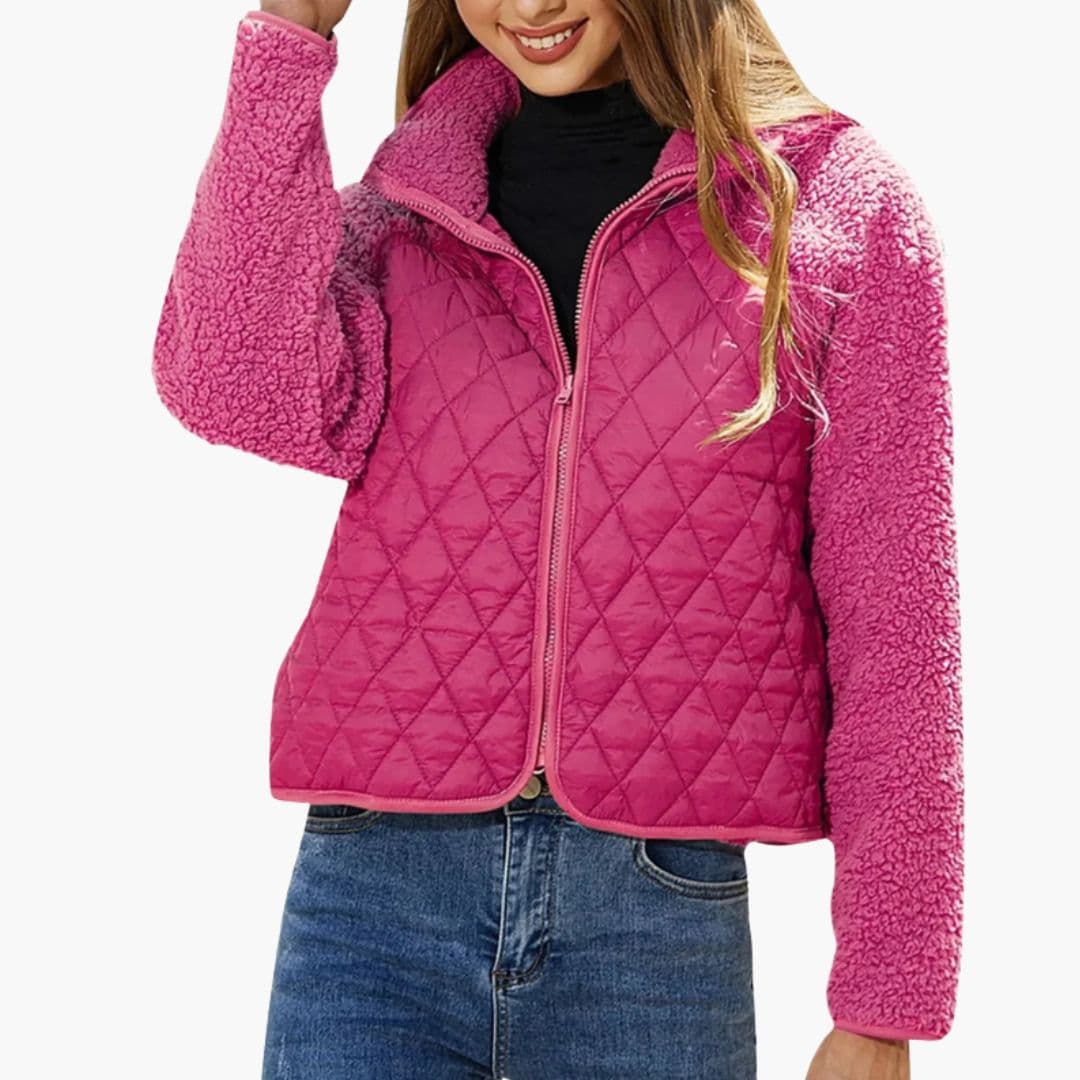 Women's black quilted zip jacket with textured sleeves, stand-up collar, and chic hip-length fit