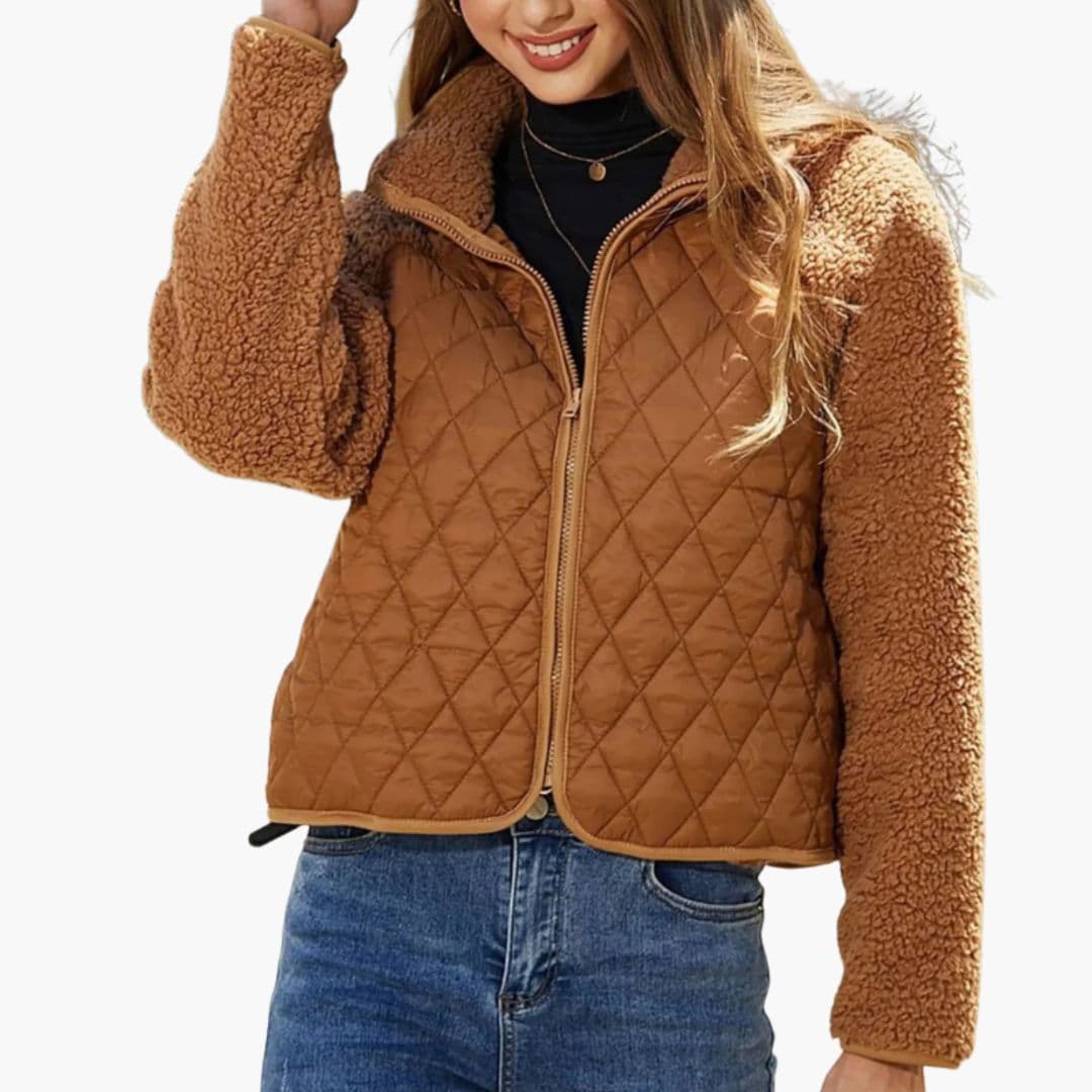 Women's black quilted zip jacket with textured sleeves, stand-up collar, and chic hip-length cut