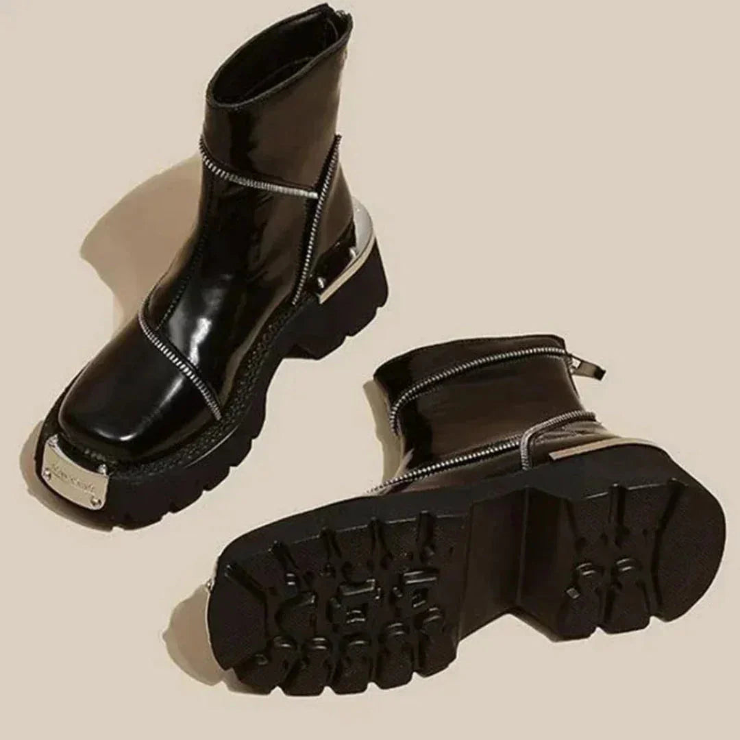Glossy black patent ankle boots bold asymmetric zippers metallic hardware chunky lug sole urban style
