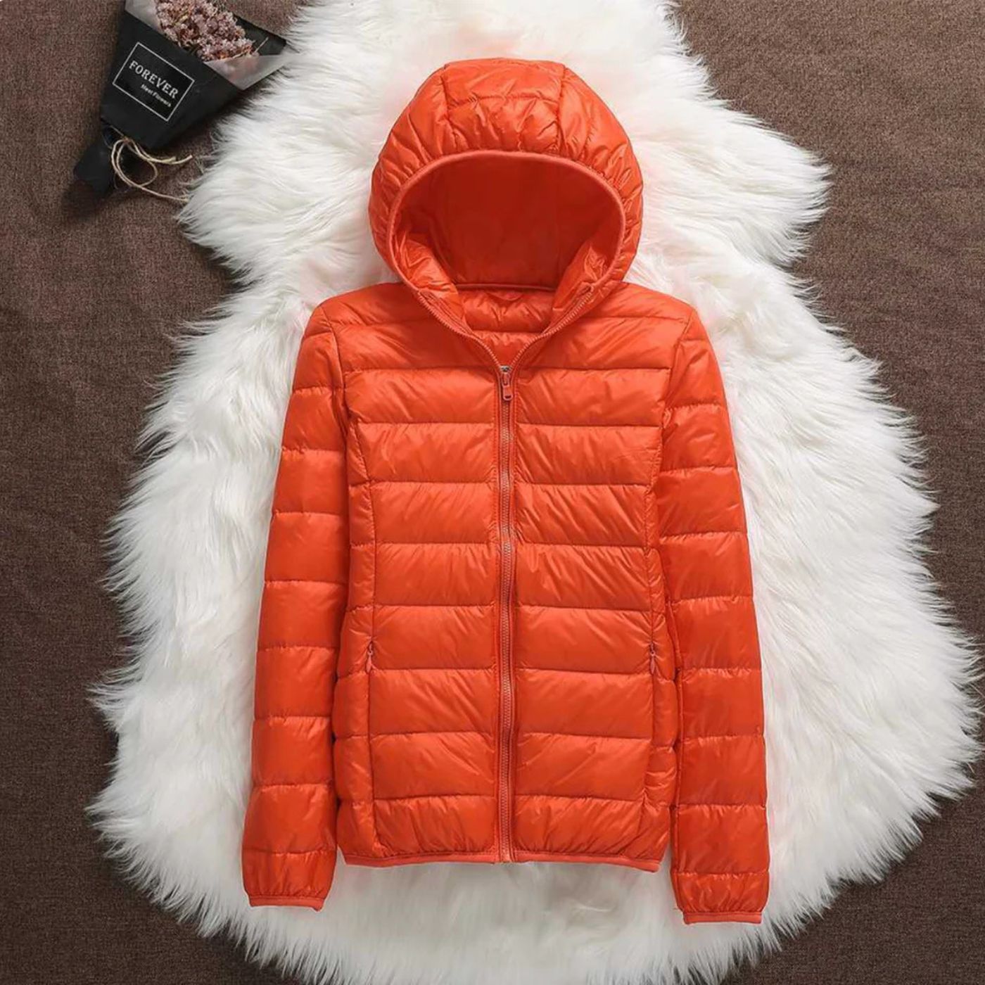 Lightweight quilted puffer hooded jacket in neutral tone, slim packable fit for outdoor wear
