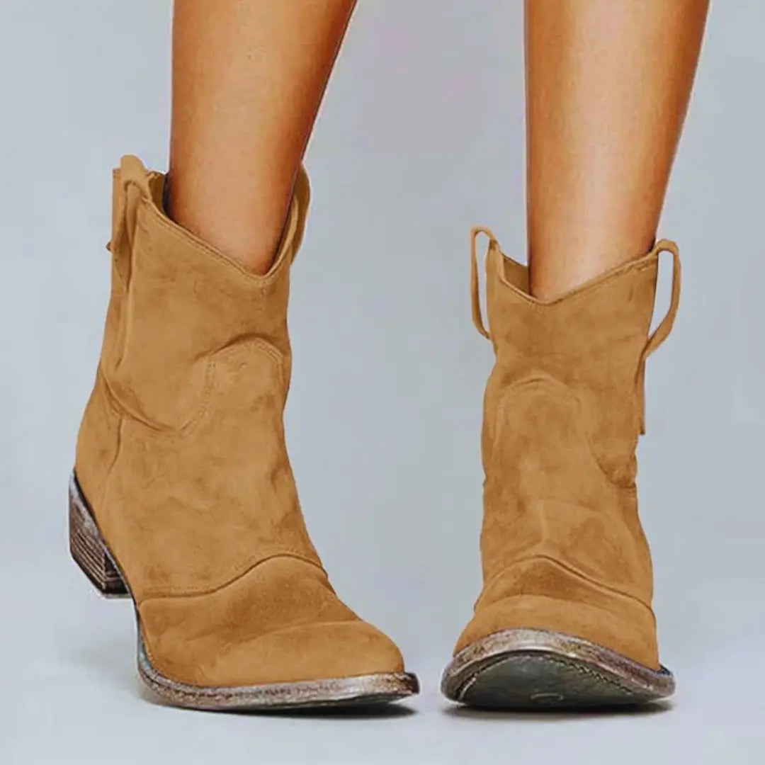 Women's vintage brown suede cowboy ankle boots with low heel and Western-inspired stitching detail