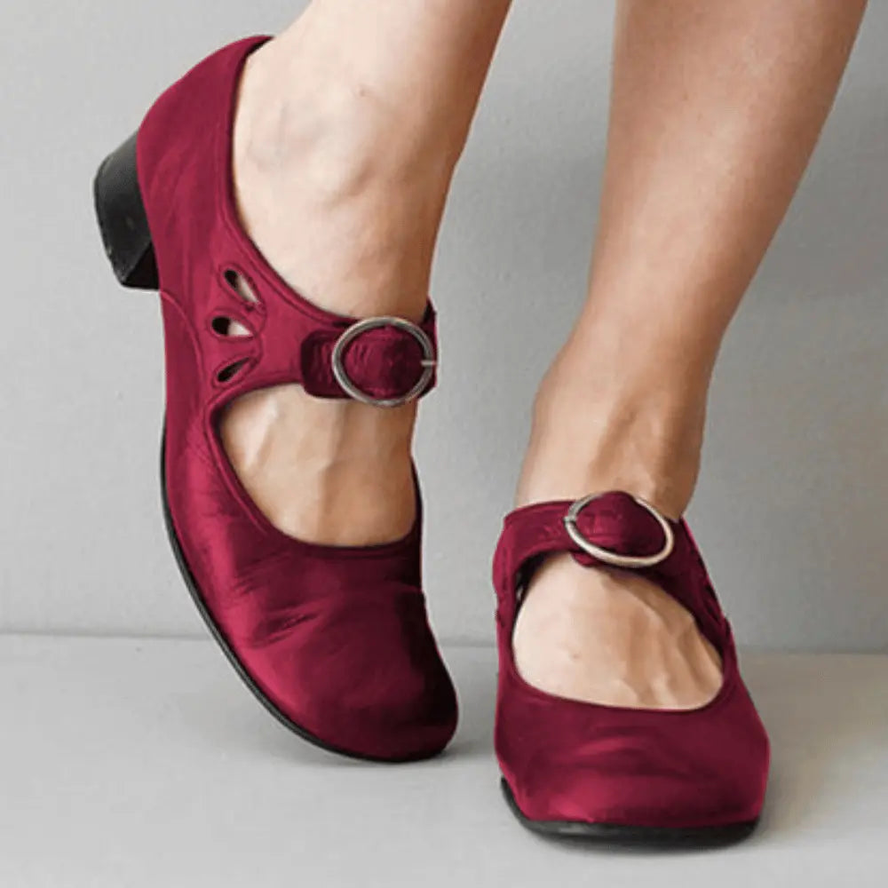 Women's vintage black Mary Jane flats with adjustable buckle strap and delicate cutout detailing