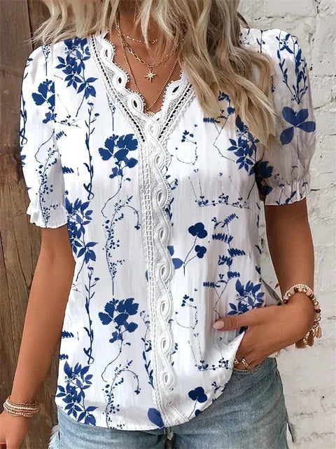 Women's floral V-neck blouse with delicate lace trim, elegant botanical print for modern professional style