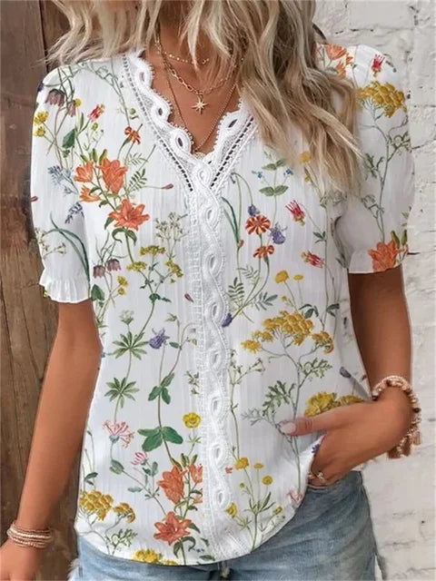 Women's floral V-neck blouse with delicate lace trim, botanical print, elegant fit for modern professionals