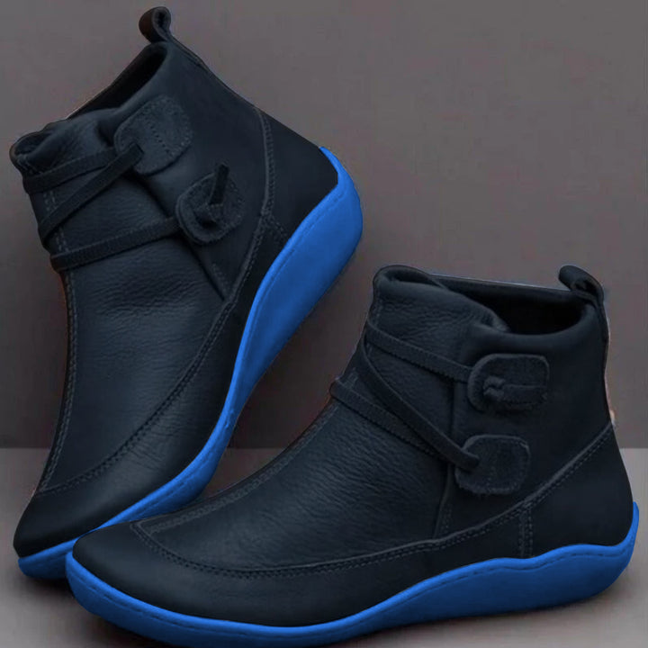 Women's waterproof slip-on ankle boots in sleek black with cushioned interior for all-season comfort