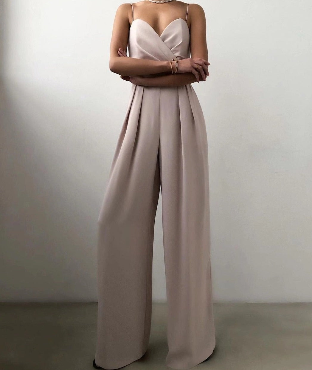 Livia black wide leg jumpsuit with chic strappy neckline and flowing silhouette for elegant all-day wear