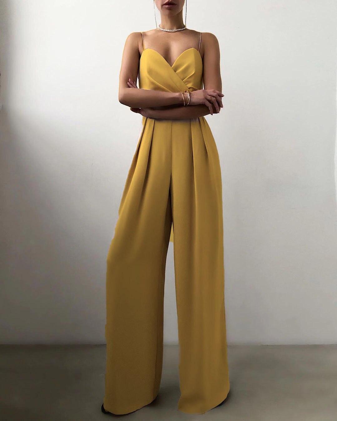 Black strappy wide-leg jumpsuit with flowing silhouette and chic contemporary neckline for women