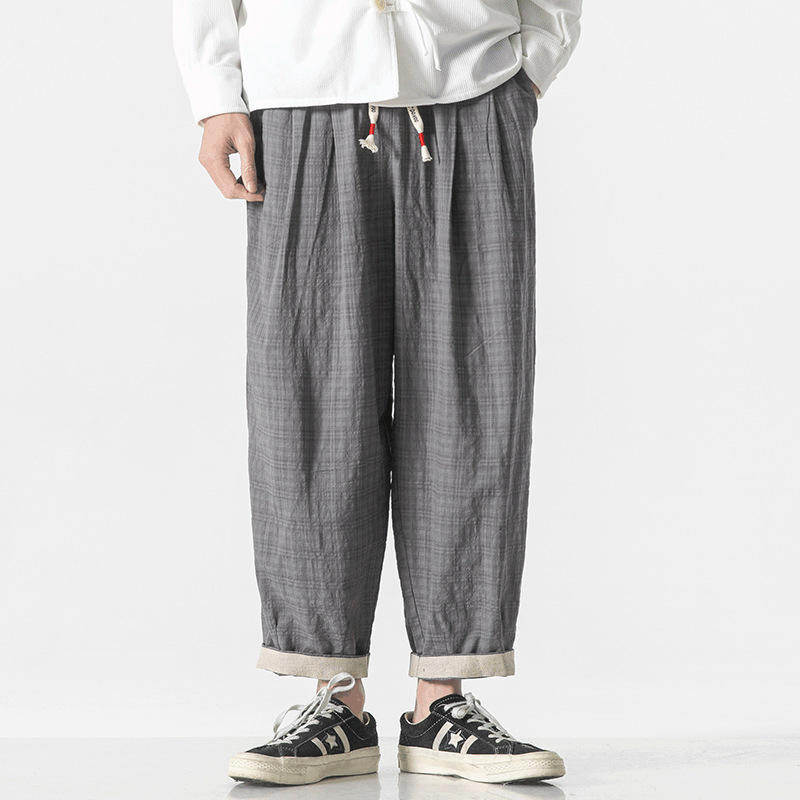 Unisex relaxed-fit micro check pants in neutral cotton blend with drawstring waist and rolled hems