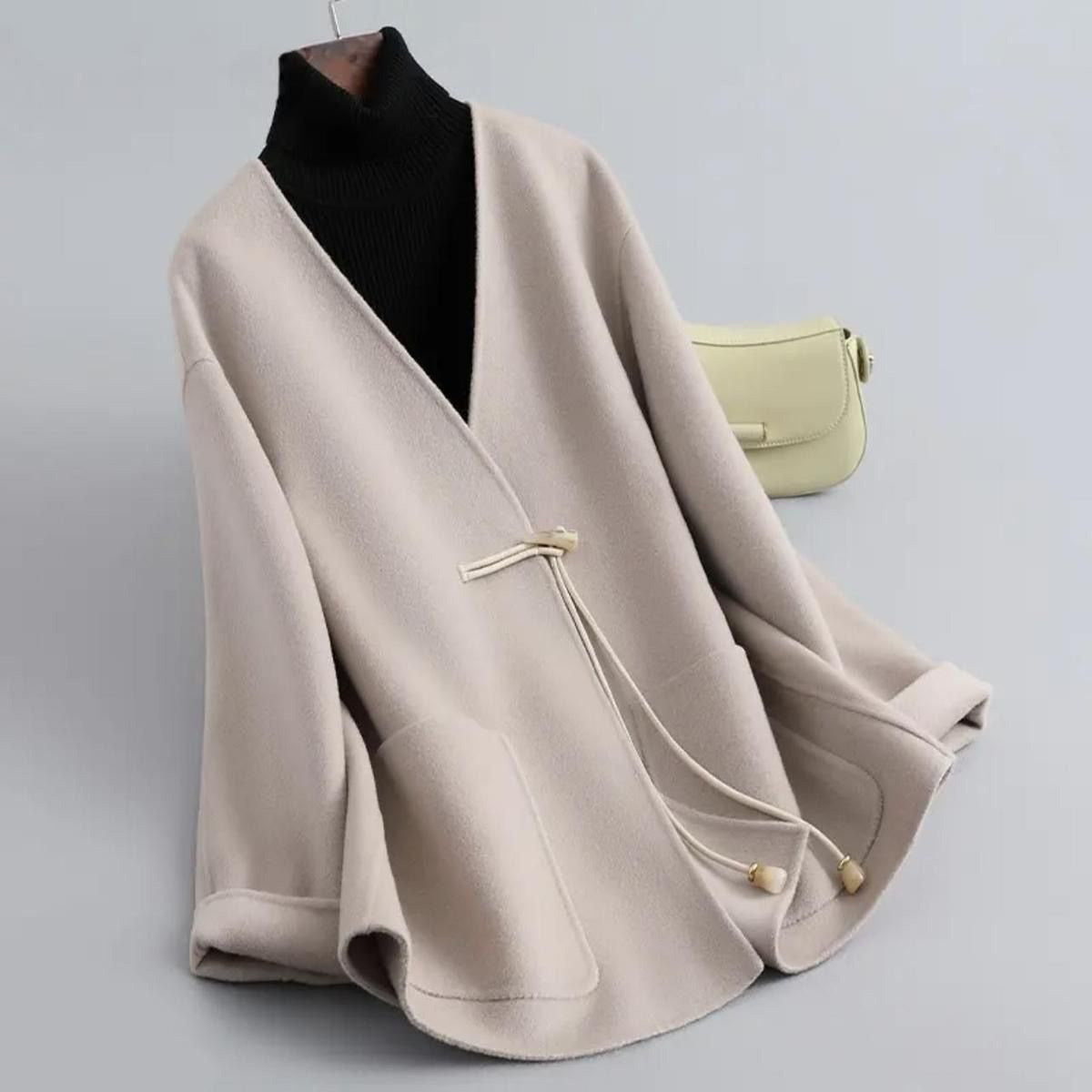 Women's beige wool-blend structured coat with minimalist silhouette and smooth itch-free finish
