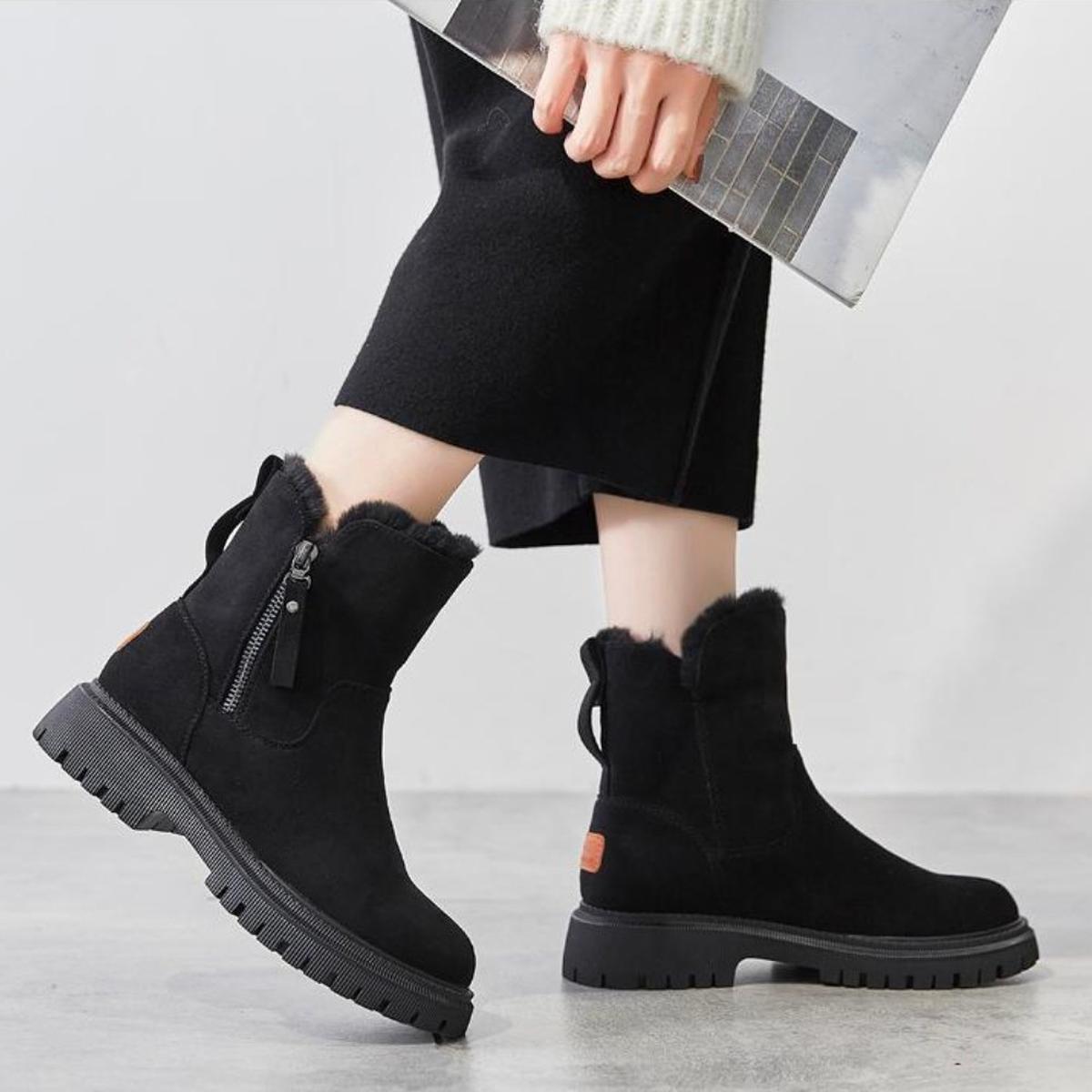 Women's black waterproof winter boots with plush fur lining, side zip, and platform sole