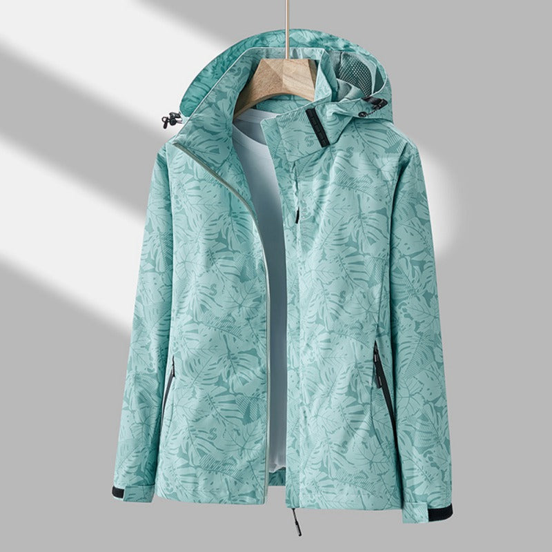 Women's lightweight windproof waterproof jacket with tonal leaf print and adjustable hood for active wear