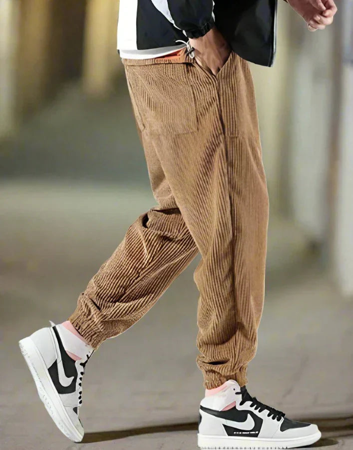 Men's wide-leg corduroy trousers in neutral tone, relaxed contemporary silhouette with textured ribbed fabric