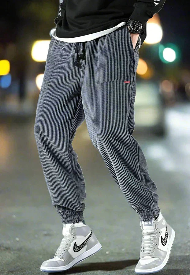 Men's wide-leg corduroy trousers in neutral tone, relaxed contemporary fit with textured ribbed fabric