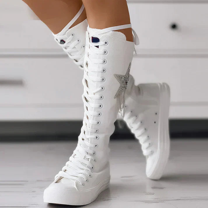 Women's lace-up ankle boots in neutral tones with playful tassel details for casual everyday style