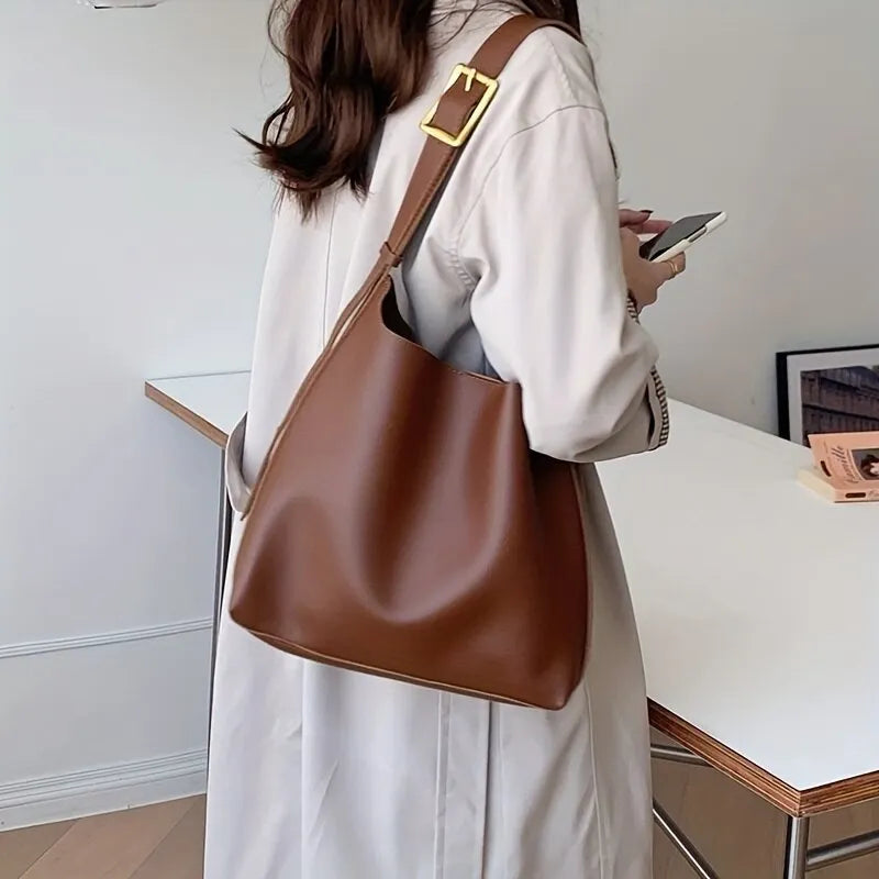 Isla slouchy faux leather shoulder bag in neutral tone with minimalist buckle detail and adjustable strap