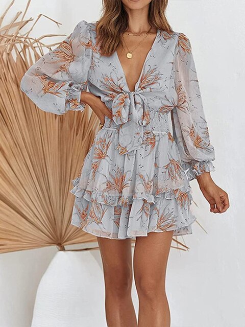 Women's mini fit-and-flare dress with plunging V-neck tie, long sleeves, smocked waist, and ruffle details