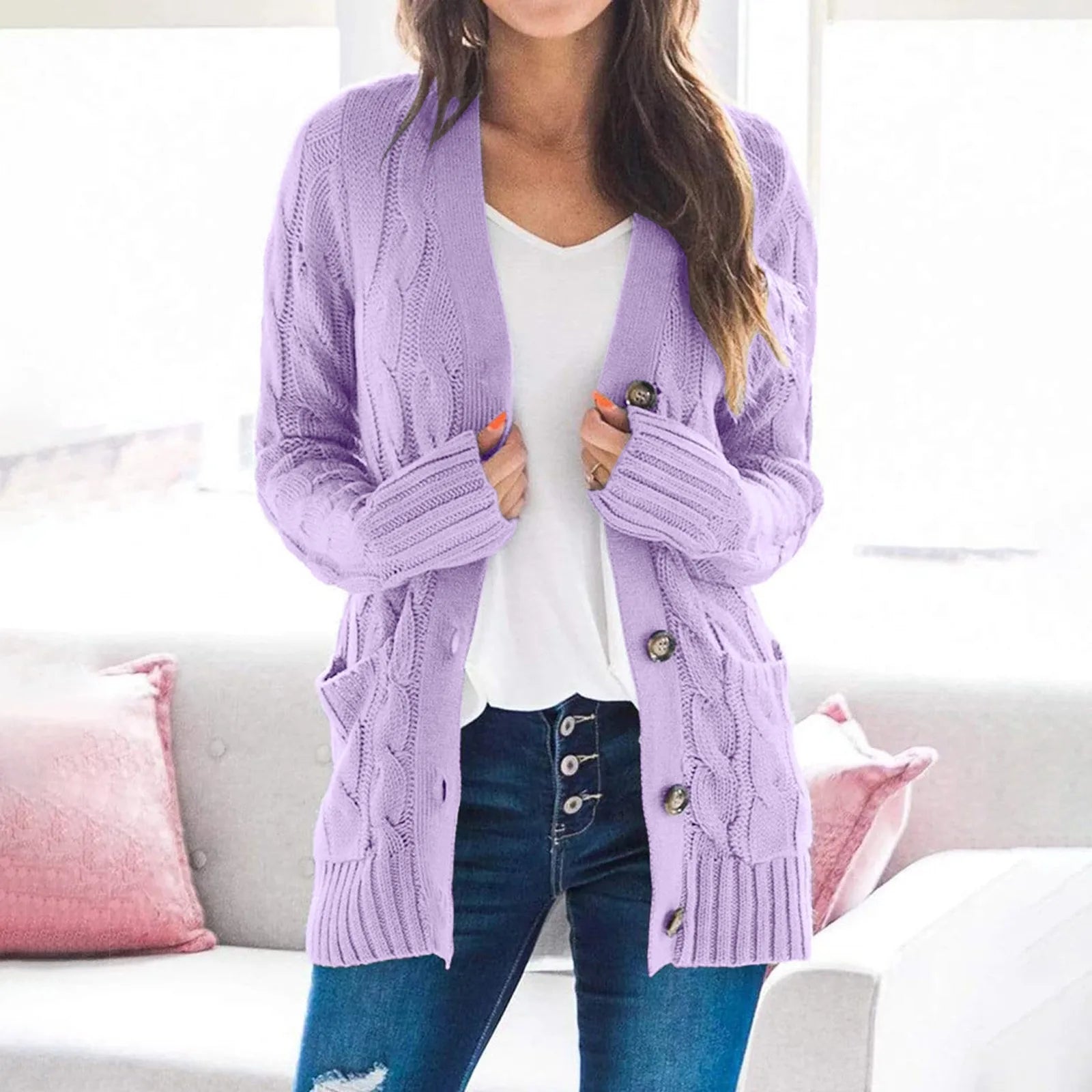 Women's cable knit button cardigan in neutral tone, hip-length cozy acrylic layering piece with pockets