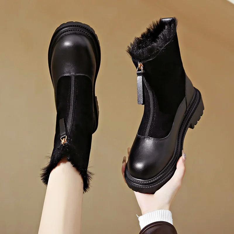 Women's black faux leather ankle boots with fur lining, chunky sole, and sleek winter-ready silhouette