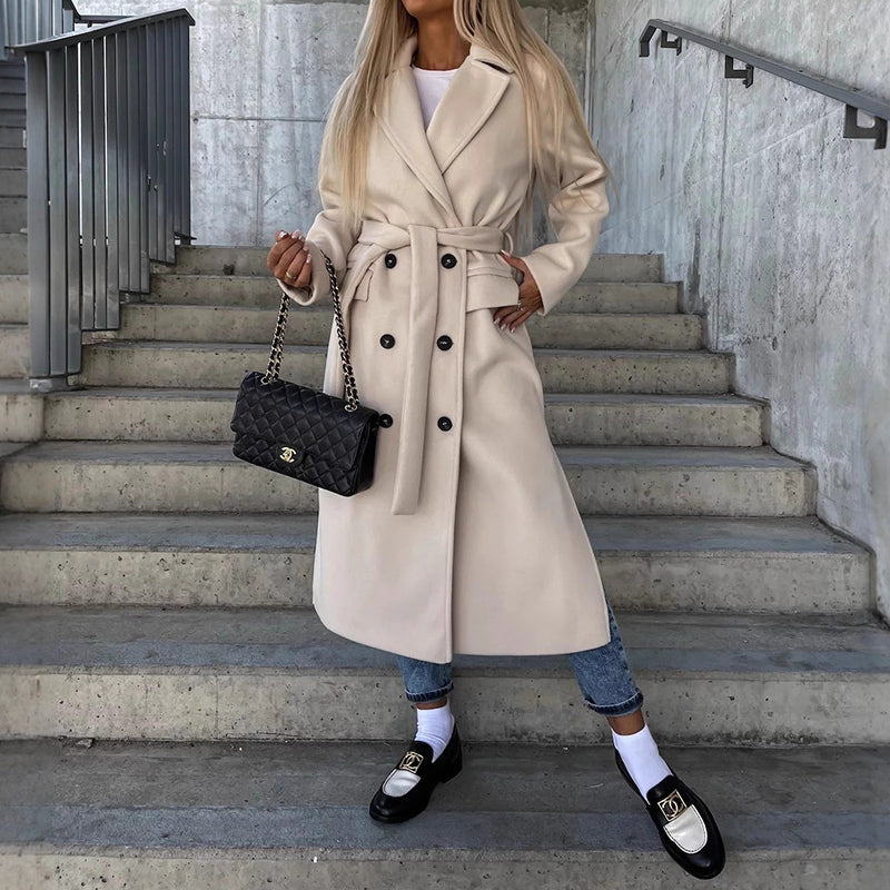 Women's long double-breasted coat with notched lapel, side pockets, sleek structured silhouette