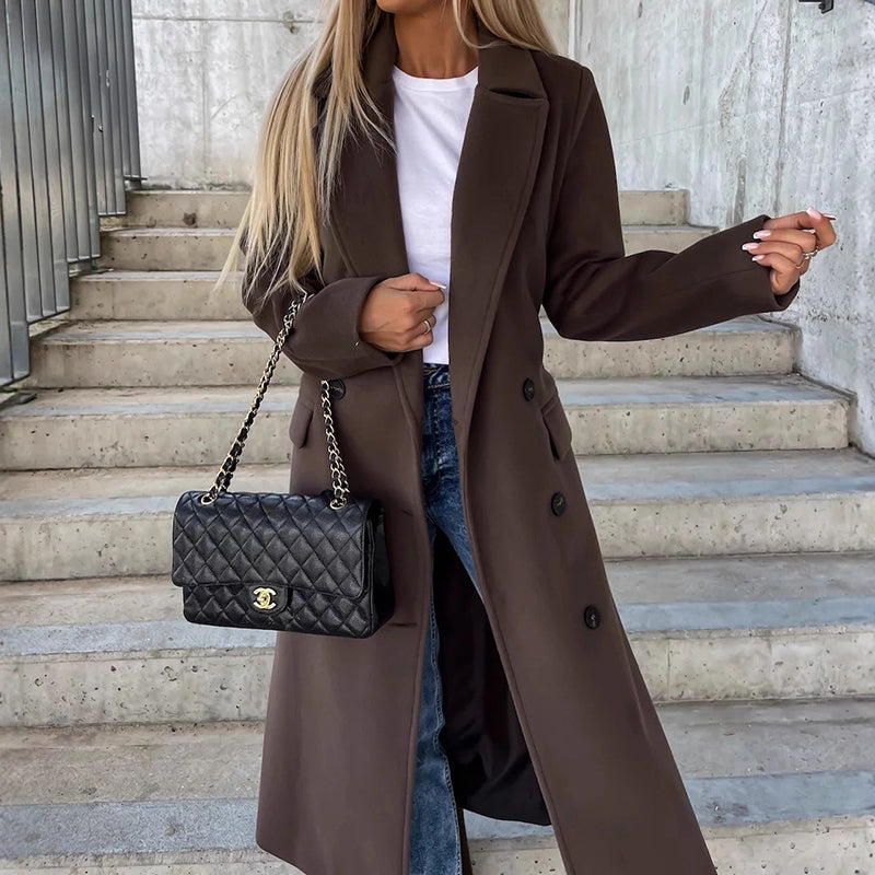 Women's long double-breasted coat with notched lapel, side pockets, structured silhouette for elegant layering