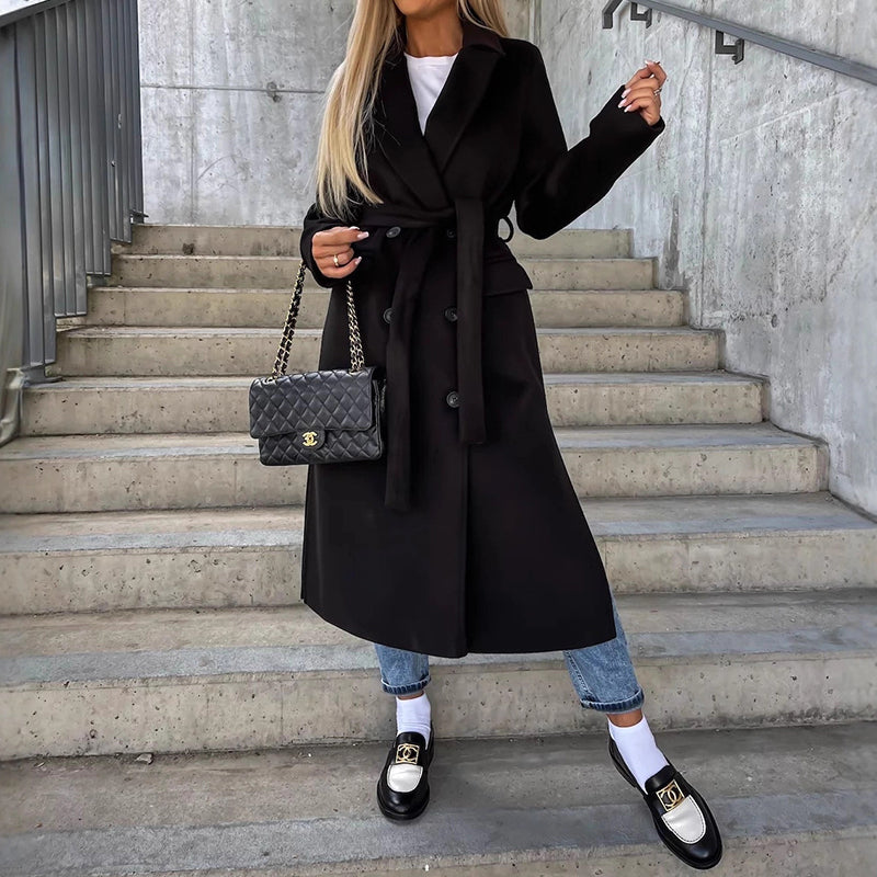 Women's long double-breasted coat with notched lapel, side pockets, sleek silhouette for layering