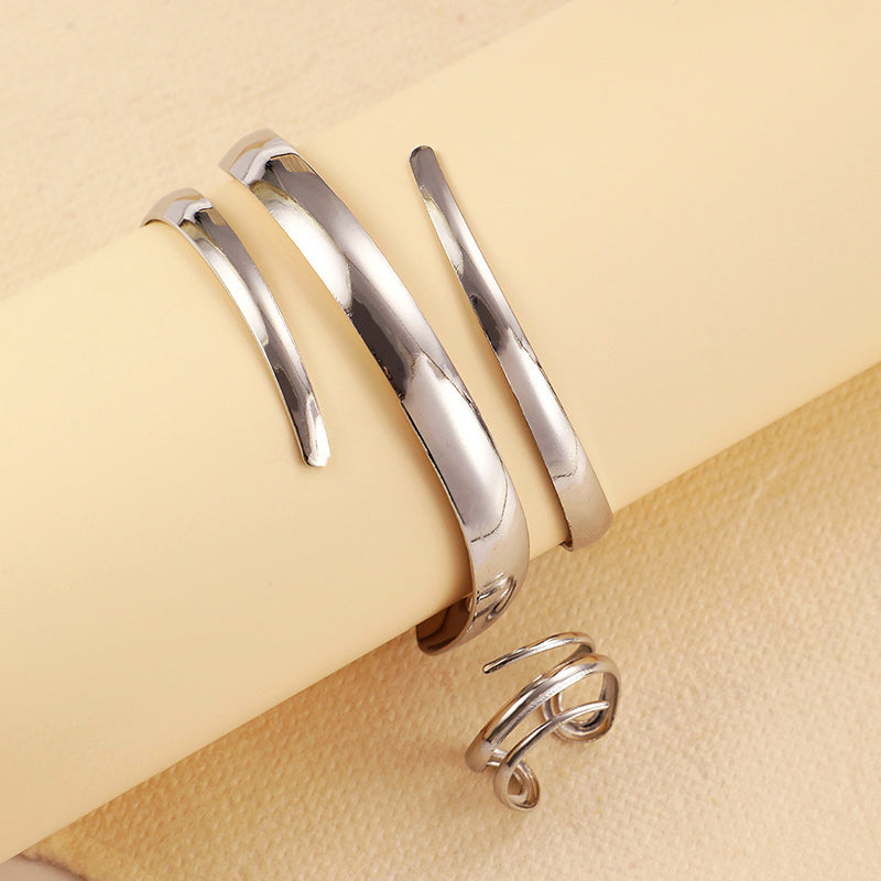 Women's sculpted wrap bracelet and ring set in stainless steel with open curve light-catching design