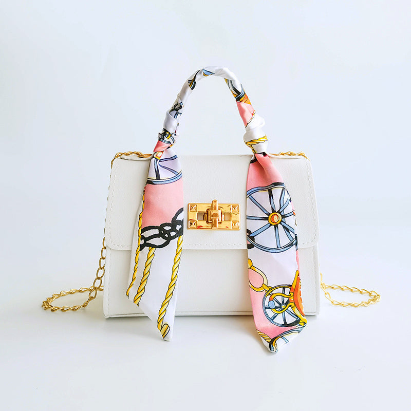 Women's small structured flap bag with scarf handle, gold twist-lock clasp, compact everyday chic silhouette