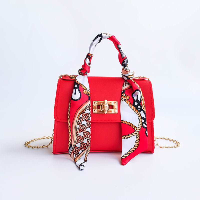 Women's small structured flap bag with scarf handle and gold twist-lock clasp, chic everyday design