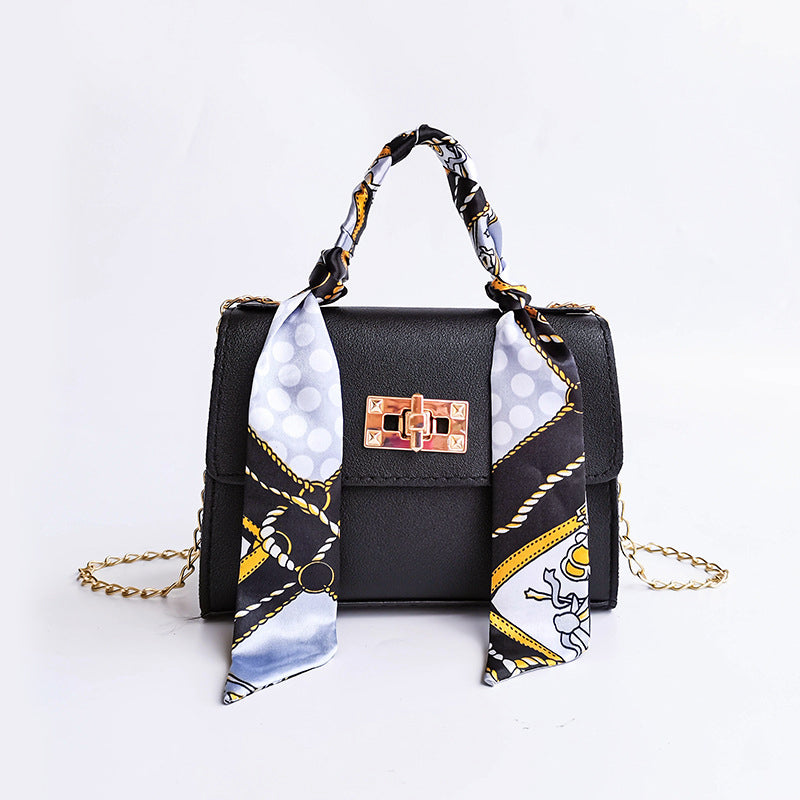 Women's small structured flap bag with scarf handle, gold twist-lock clasp, compact everyday chic silhouette