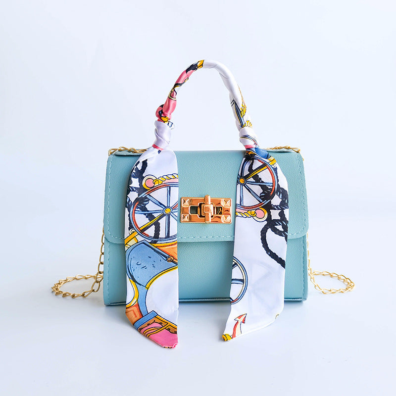 Women's small structured flap bag with scarf handle, gold twist-lock clasp, compact chic silhouette