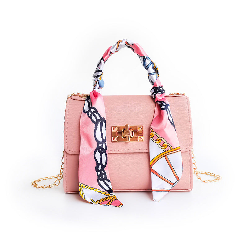 Women's small structured flap bag with scarf handle, gold twist-lock clasp, compact everyday chic silhouette