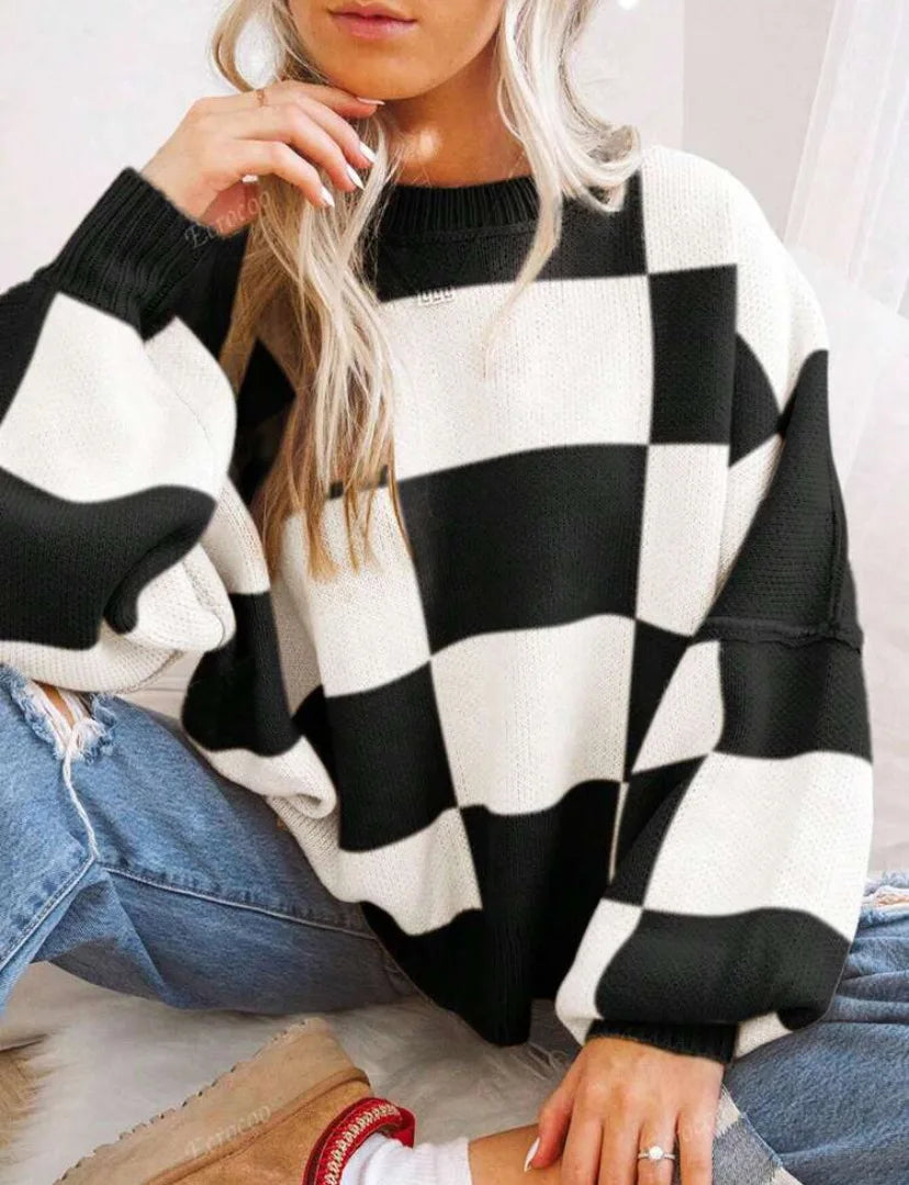 Women's oversized checkerboard knit sweater in two-tone block pattern, cozy relaxed fit for layering