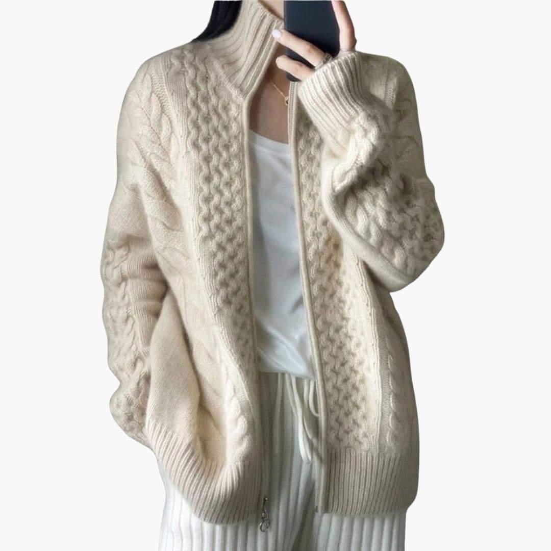 Women's cable knit cardigan with high ribbed collar, full-length zipper, structured cozy layering piece
