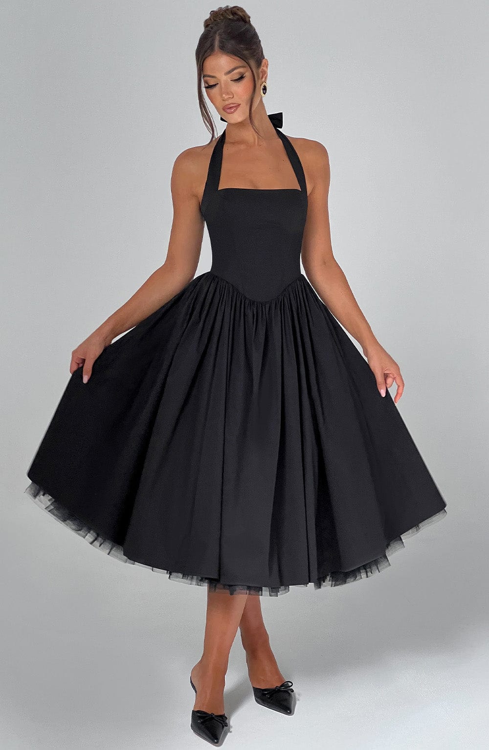 White halter midi dress fitted bodice full skirt elegant wedding guest silhouette