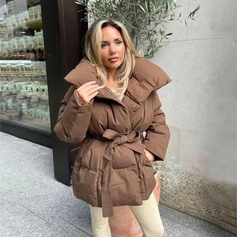 Women's black belted puffer coat with cinched waist, flattering silhouette, and cozy padded insulation