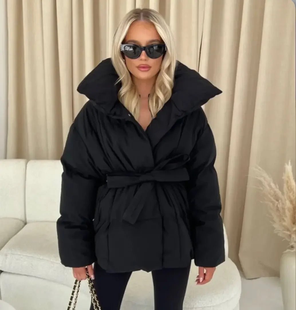 Women's black belted puffer coat with cinched waist, flattering silhouette for cozy winter style