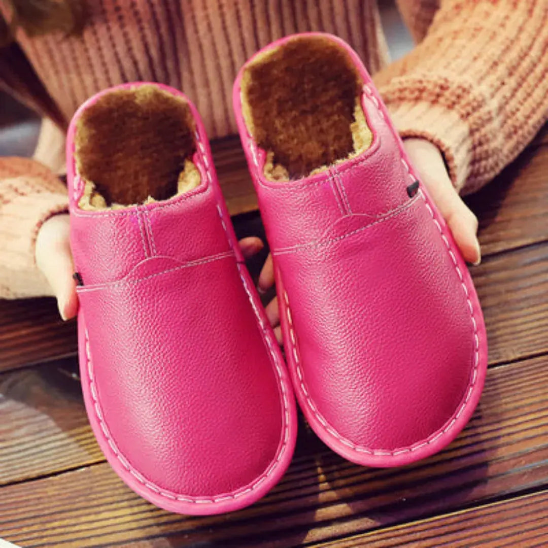 Women's black faux leather slip-on slippers with plush fur lining and cushioned non-slip sole