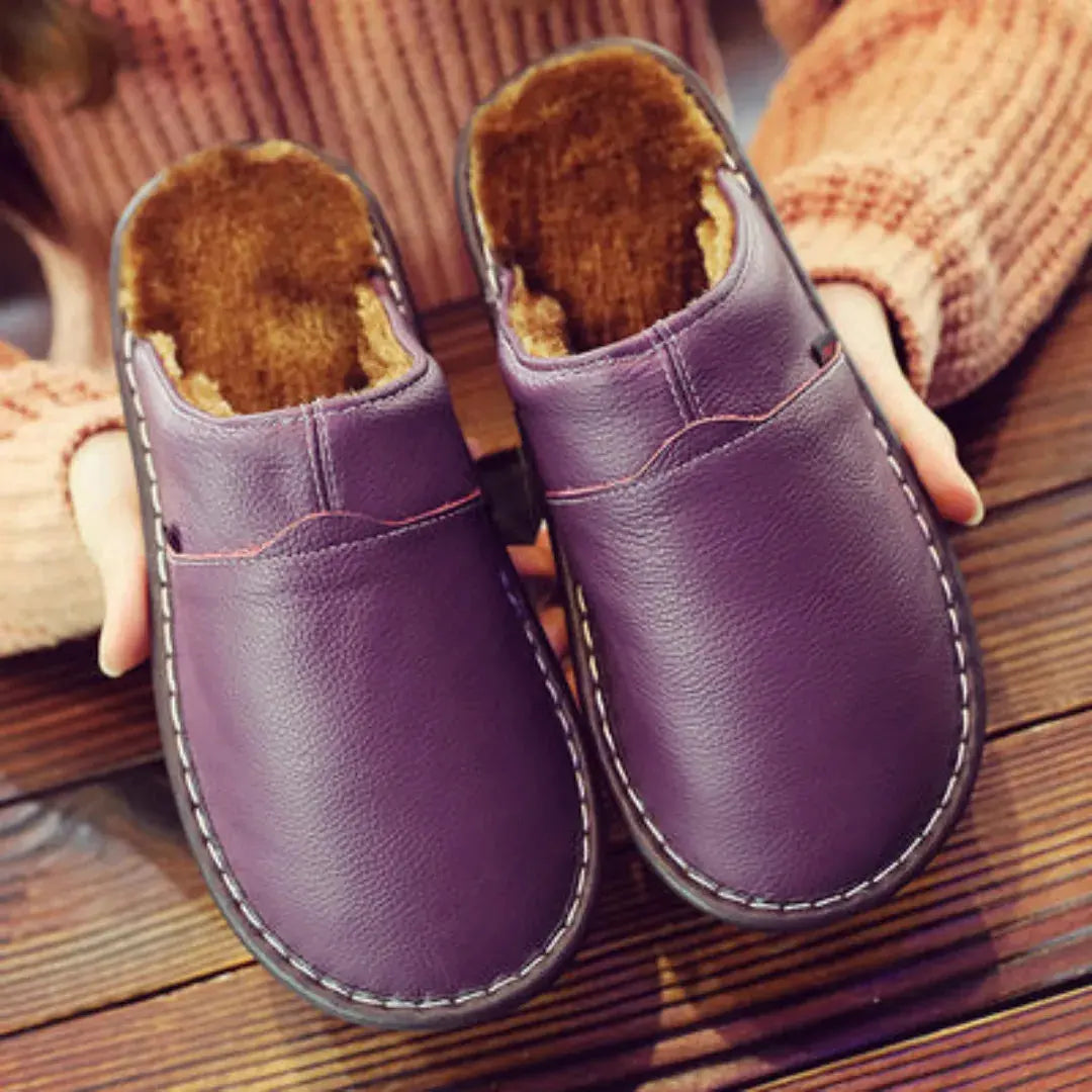 Women's black faux leather slip-on slippers with plush fur lining and cushioned non-slip sole