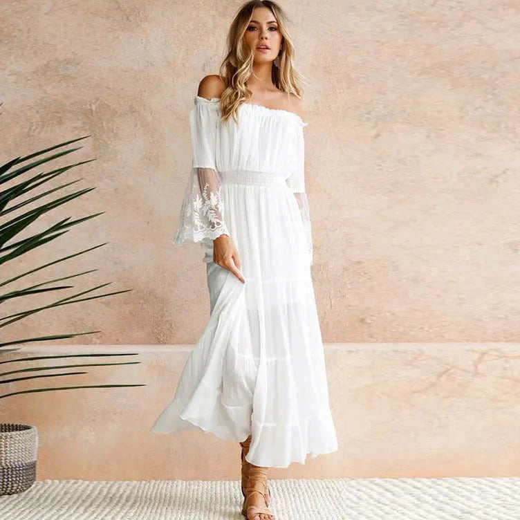 White off-shoulder lace maxi dress with smocked bodice and flowing tiered skirt for wedding guests
