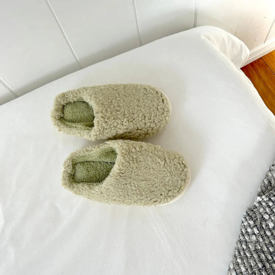 Women's plush slip-on house slippers in soft fleece with cushioned insole and fluffy teddy-texture exterior