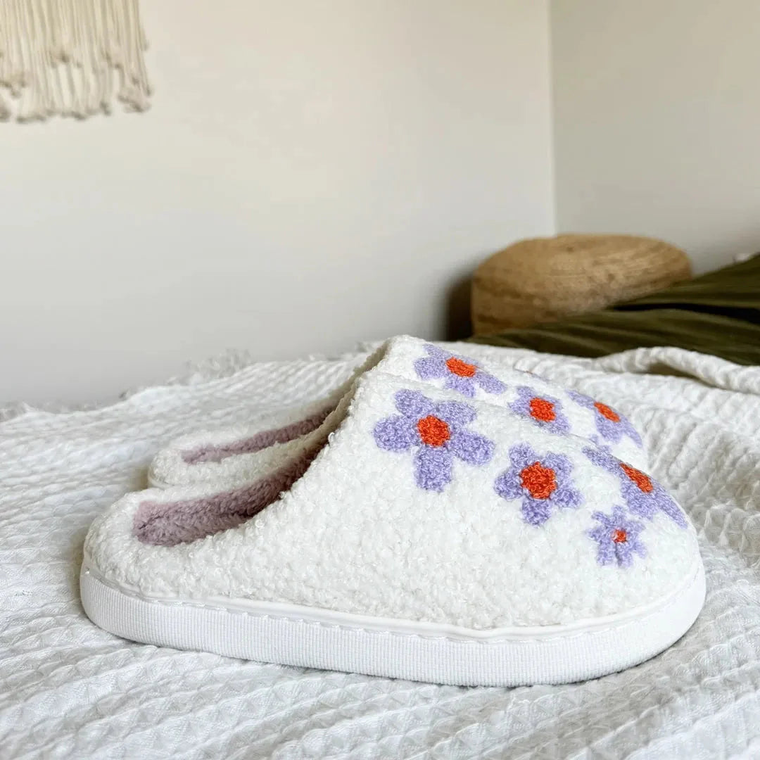 Women's purple floral fuzzy slippers with plush lining, embroidered daisies, and durable slip-on sole