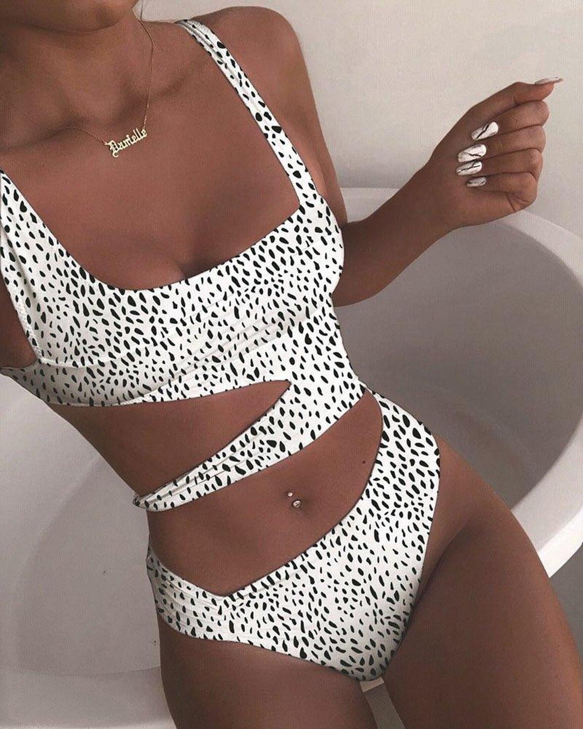 Black push-up one-piece swimsuit with asymmetric cutout design and sculpted angled lines for curves