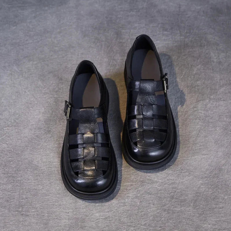 Women's black genuine leather low heel Roman sandals with woven cutout strap design and cushioned sole