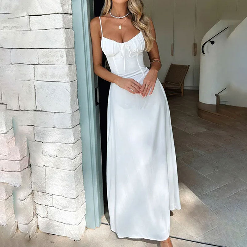 Blush satin maxi dress with ruched bodice and spaghetti straps, elegant wedding guest style