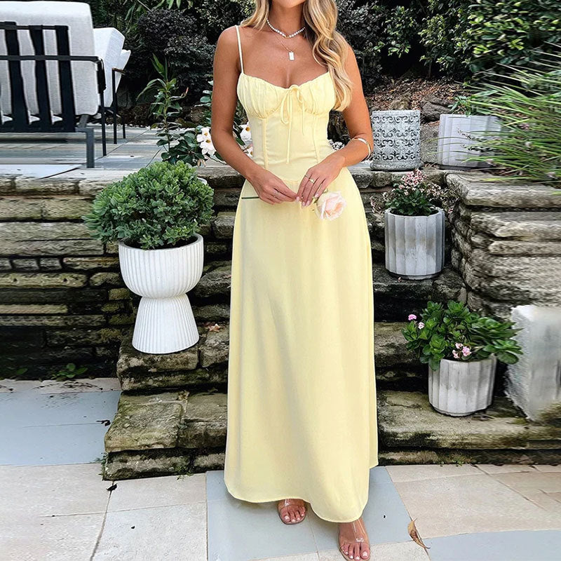 Blush satin maxi dress with ruched bodice and spaghetti straps, elegant wedding guest style