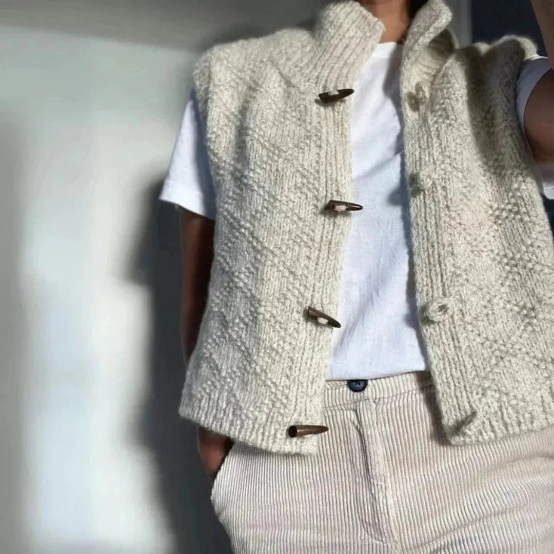 Women's hand-knit wool vest with ribbed stand collar, wooden toggle closures, cozy textured layering piece
