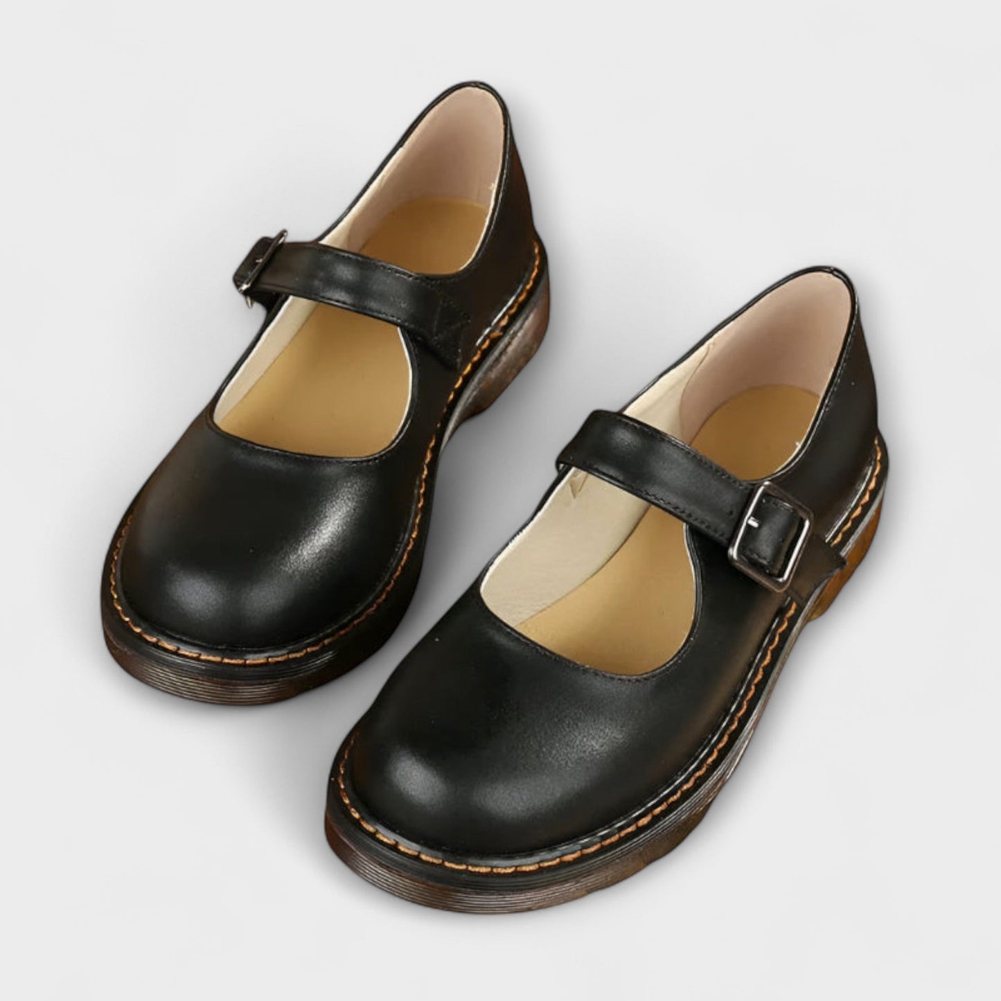 Women's black Mary Jane flats with adjustable buckle strap, round toe, and cushioned low heel